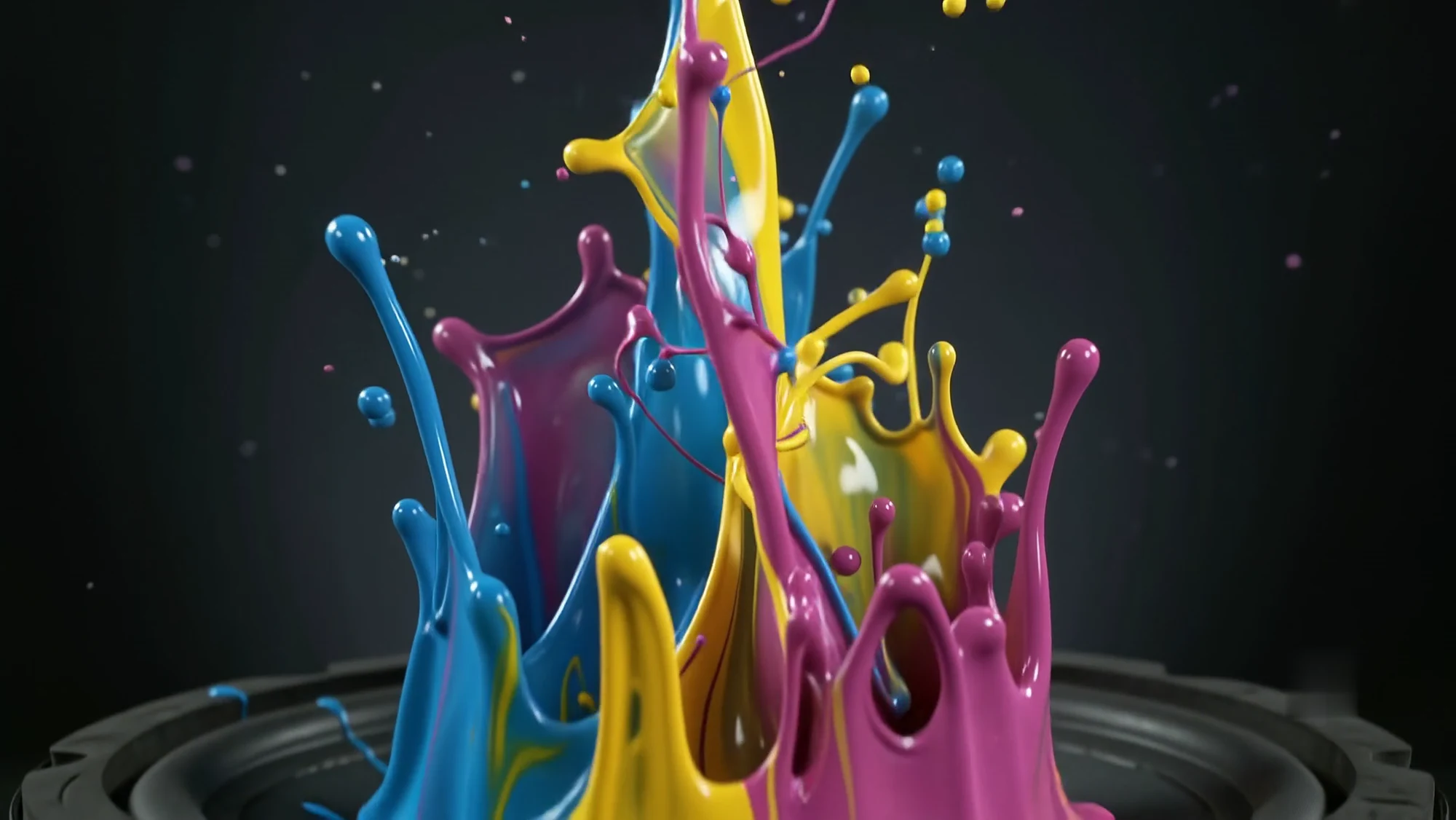 Cyan, magenta and yellow paint erupts from the black woofer cone