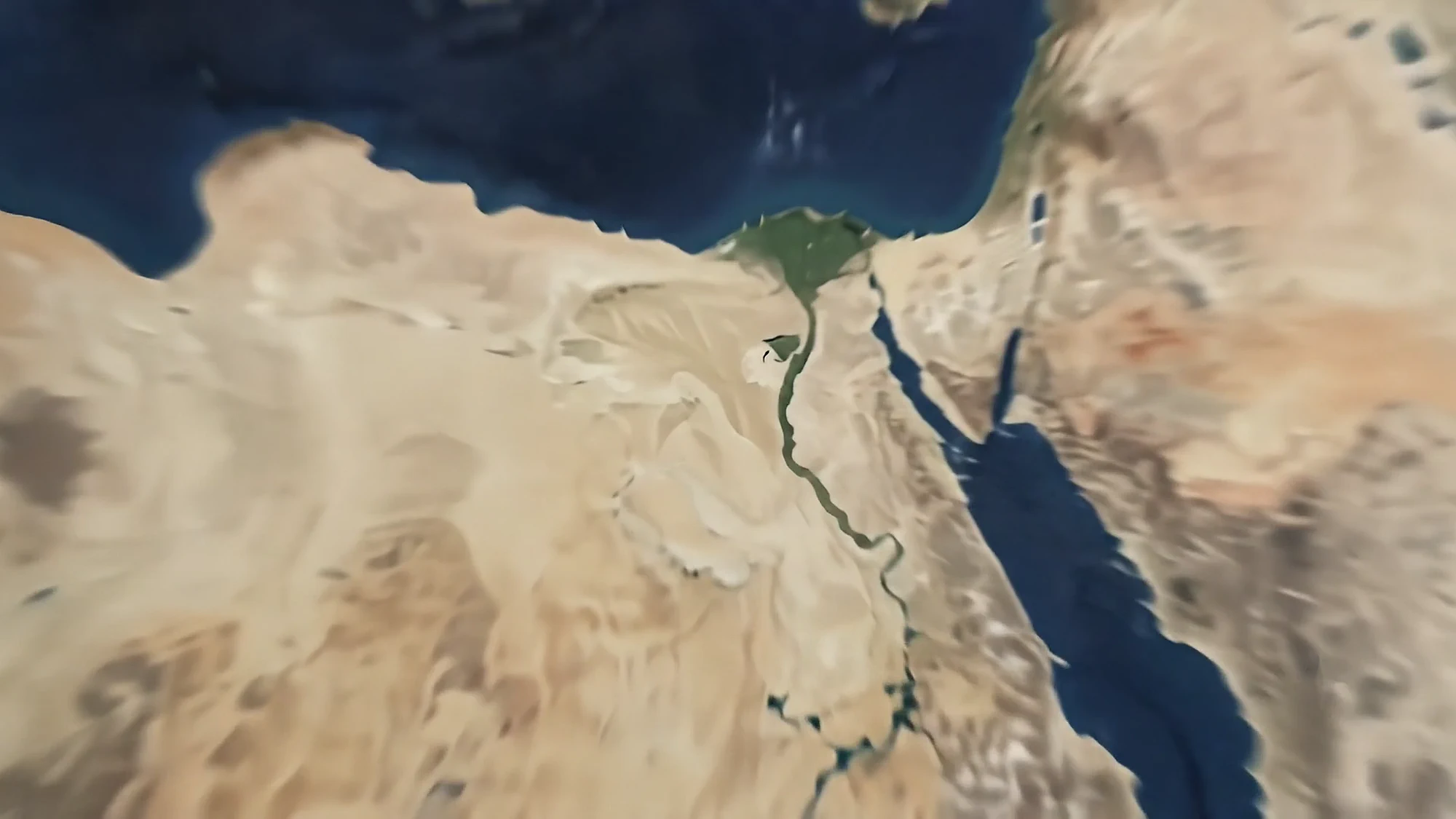 A satellite view of Egypt, the Nile delta a green fan against the sand