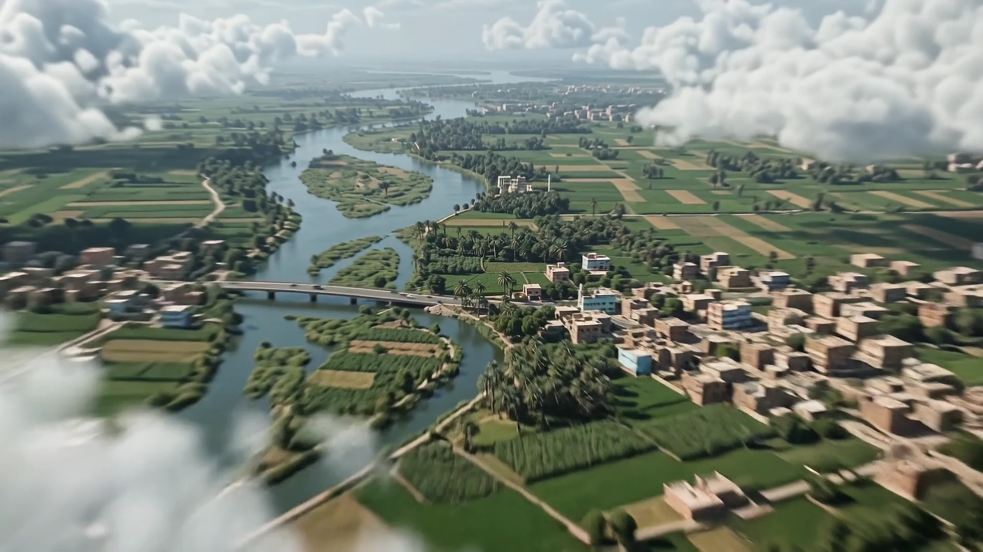 The Nile winds through green fields and villages under scattered clouds